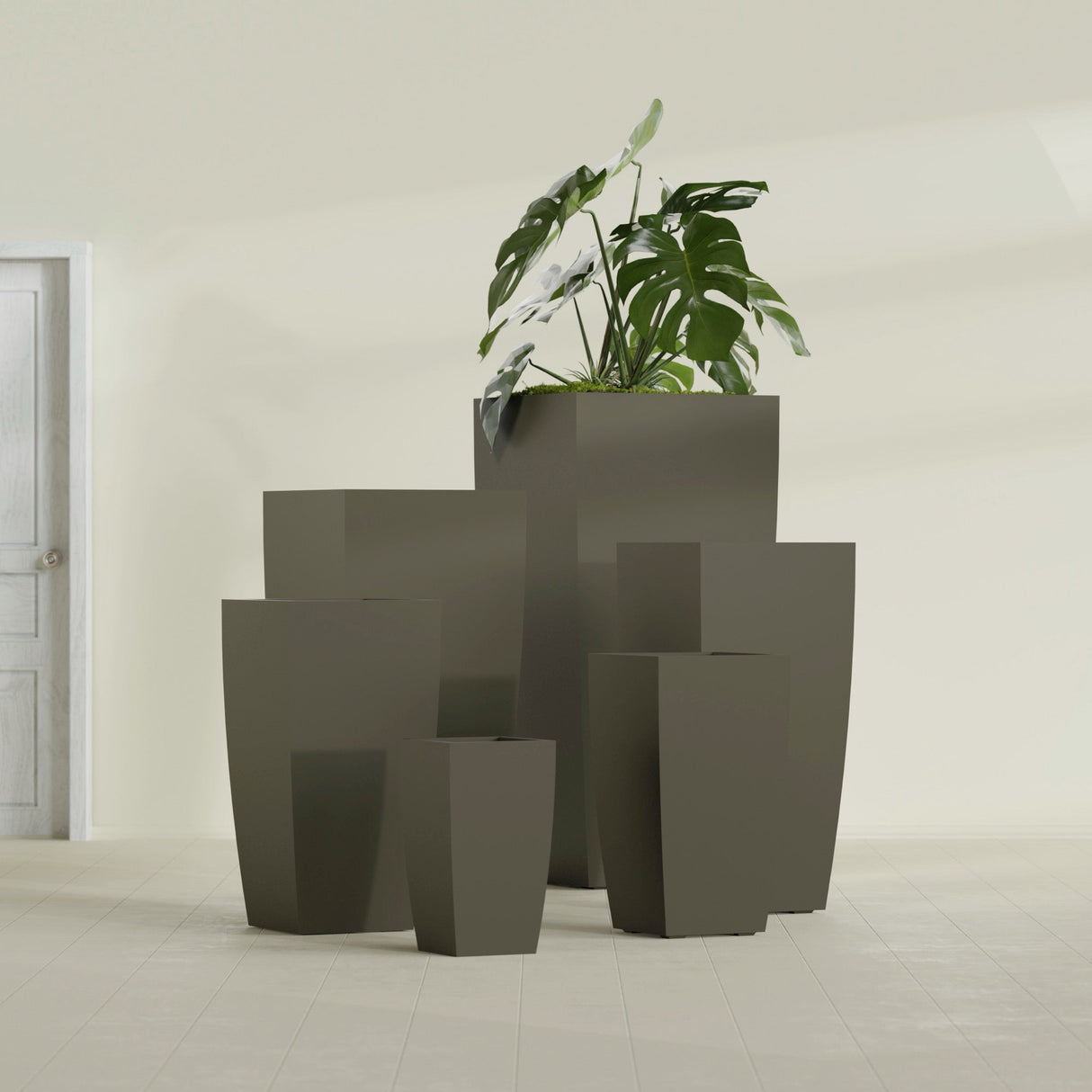Toulan Tapered Square fiberglass planter in Matte Bronze, size range, in a sunlit interior