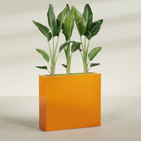 Amesbury Narrow Rectangular fiberglass planter in Gloss Tangerine, shown planted, in a sunlit interior