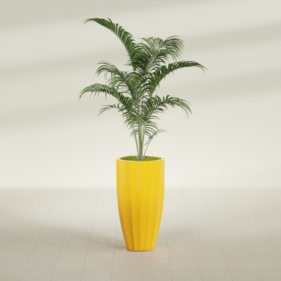 San Jose Tall Fluted fiberglass planter in Gloss Saffron, shown planted, in a sunlit interior