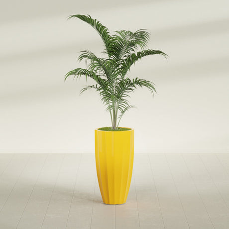 San Jose Tall Fluted fiberglass planter in Gloss Saffron, shown planted, in a sunlit interior