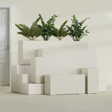 Hollywood Narrow Rectangular fiberglass planter in Satin Beige, size range, in a sunlit interior