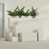 Hollywood Narrow Rectangular fiberglass planter in Satin Beige, size range, in a sunlit interior