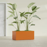 Badalona Rectangular fiberglass planter in Gloss Tangerine, shown planted, in a sunlit interior