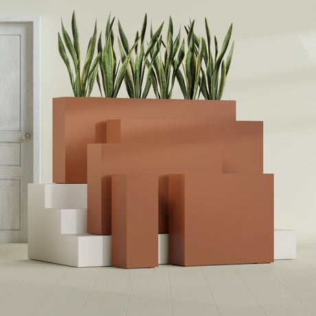Delray Corner fiberglass planter in Matte Terra Cotta, size range, in a sunlit interior