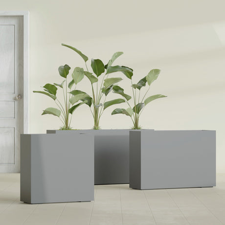 Milano Narrow Rectangular fiberglass planter in Matte Gunmetal, shown planted, in a sunlit interior