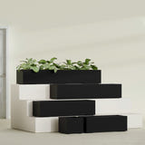 Cuba Low Rectangular fiberglass planter in Matte Black, size range, in a sunlit interior