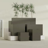 Brisbane Corner fiberglass planter in Matte Bronze, size range, in a sunlit interior