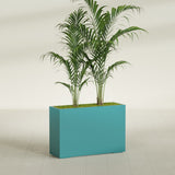 Potsdam Corner fiberglass planter in Satin Seafoam Green, shown planted, in a sunlit interior