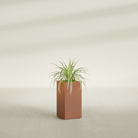 Hollywood Corner fiberglass planter in Matte Terra Cotta, shown planted, in a sunlit interior
