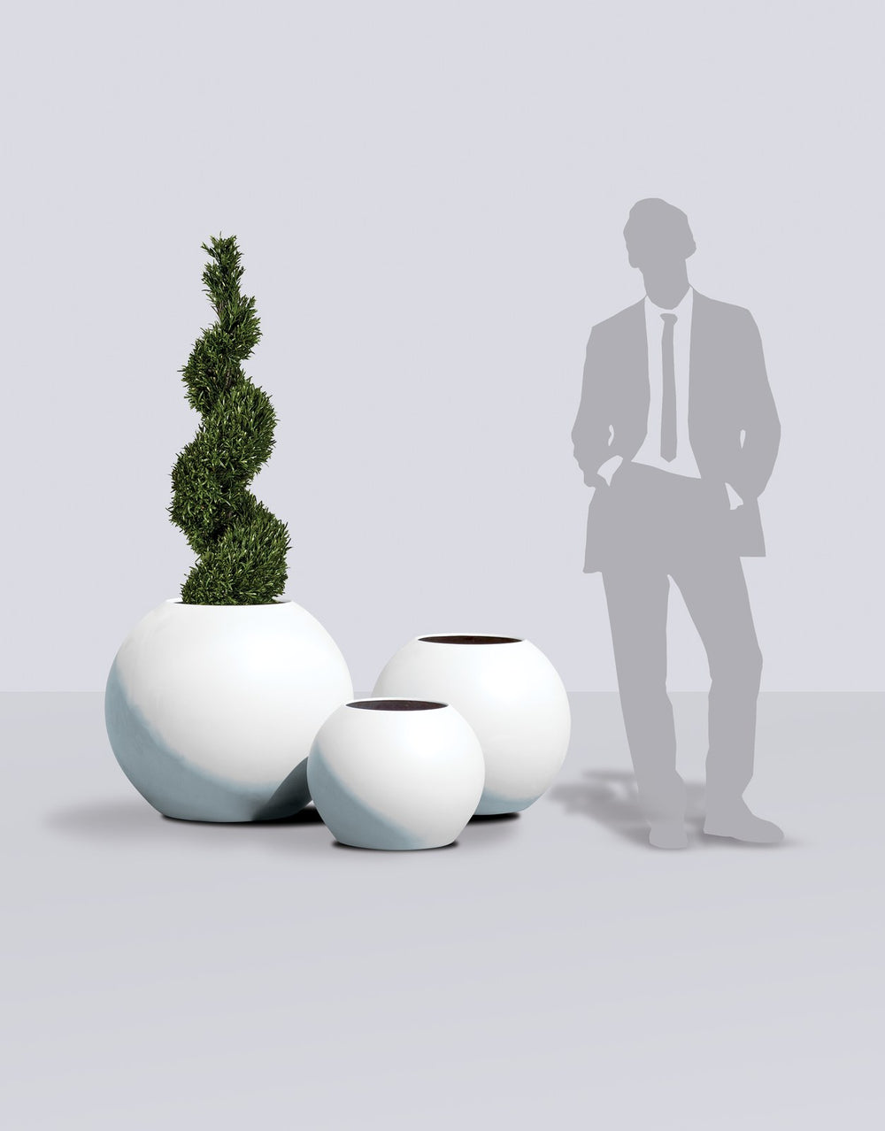 Globe Round Sphere fiberglass planter size range shown to scale beside a standing figure