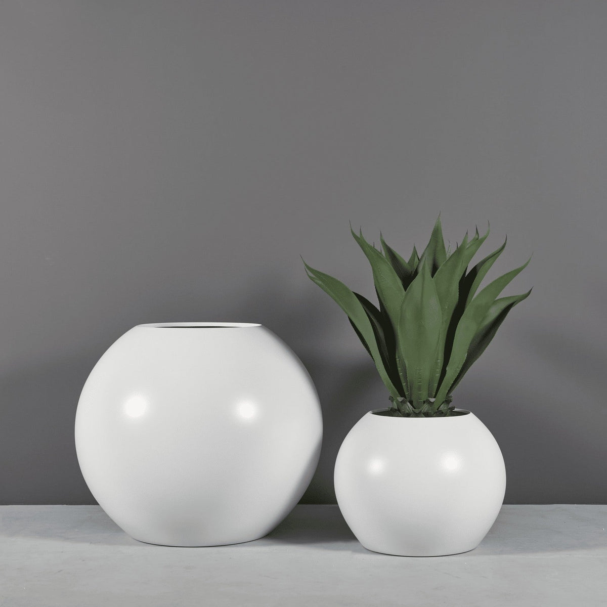 Globe round sphere fiberglass planter, two sizes, one planted with agave