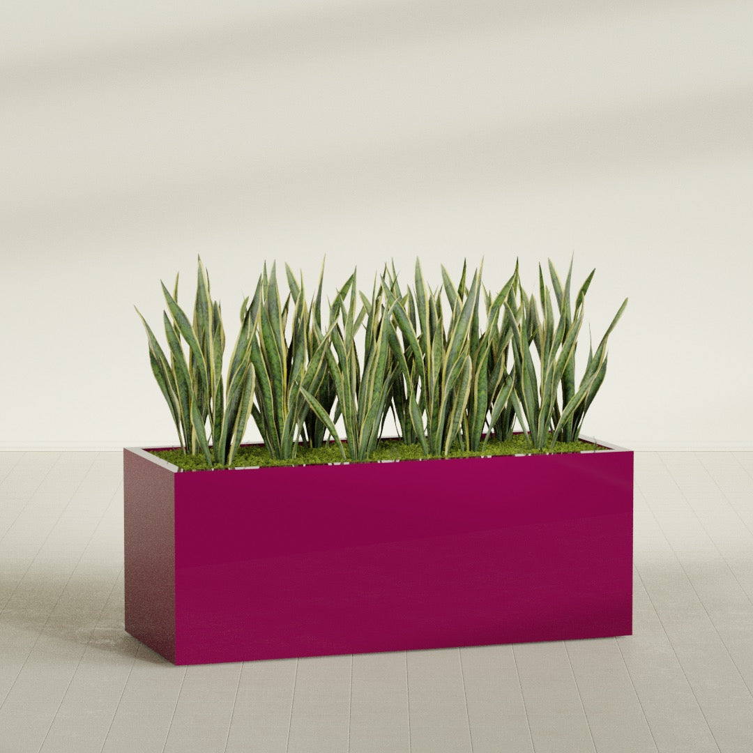 Granada rectangular fiberglass planter in Gloss Eggplant, 60 × 24 × 24 in, shown planted in a room