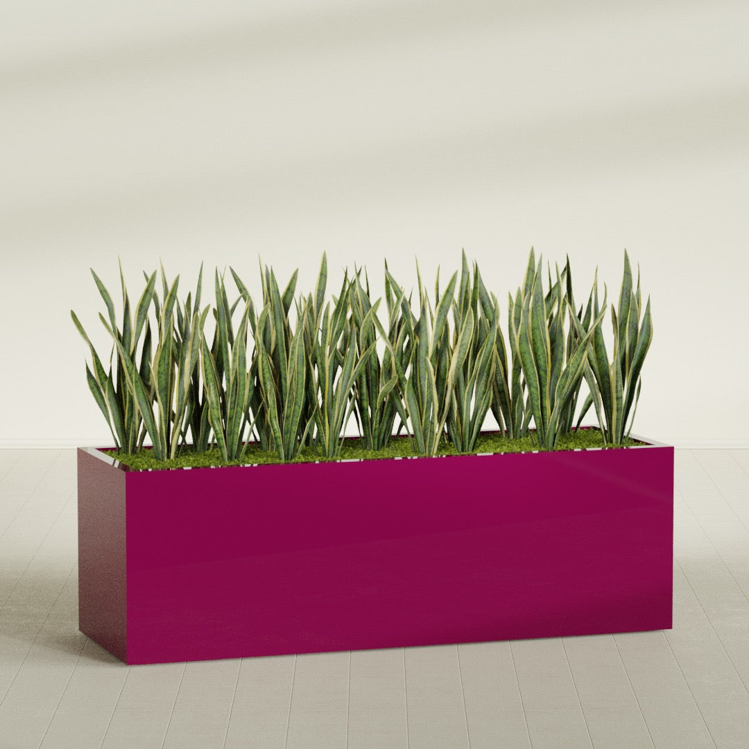 Granada rectangular fiberglass planter in Gloss Eggplant, 72 × 24 × 24 in, shown planted in a room