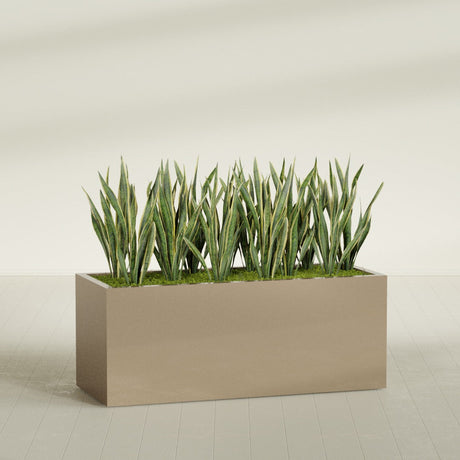 Granada rectangular fiberglass planter in Gloss Metallic Gold, 60 × 24 × 24 in, shown planted in a room