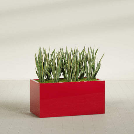 Granada rectangular fiberglass planter in Gloss Red, 48 × 24 × 24 in, shown planted in a room