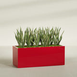 Granada rectangular fiberglass planter in Gloss Red, 60 × 24 × 24 in, shown planted in a room