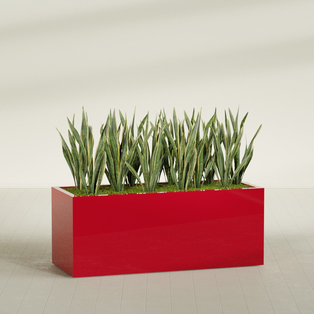 Granada rectangular fiberglass planter in Gloss Red, 60 × 24 × 24 in, shown planted in a room