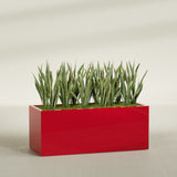 Granada rectangular fiberglass planter in Gloss Red, 60 × 24 × 24 in, shown planted in a room