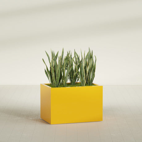Granada rectangular fiberglass planter in Gloss Saffron, 36 × 24 × 24 in, shown planted in a room