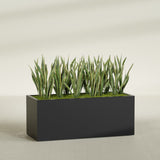 Granada rectangular fiberglass planter in Matte Black, 60 × 24 × 24 in, shown planted in a room
