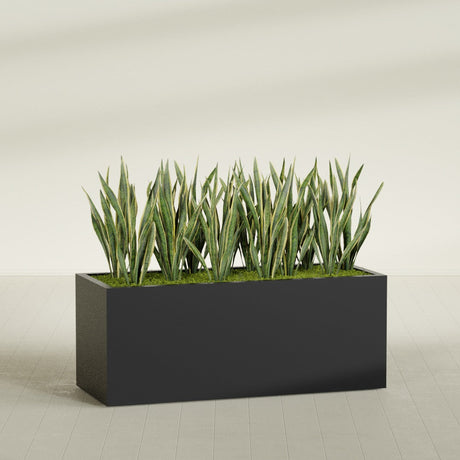 Granada rectangular fiberglass planter in Matte Black, 60 × 24 × 24 in, shown planted in a room
