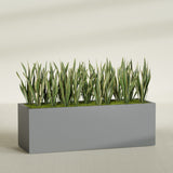 Granada rectangular fiberglass planter in Matte Gunmetal, 72 × 24 × 24 in, shown planted in a room