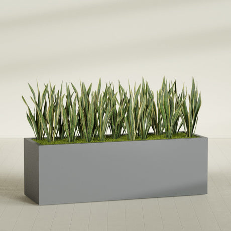 Granada rectangular fiberglass planter in Matte Gunmetal, 72 × 24 × 24 in, shown planted in a room