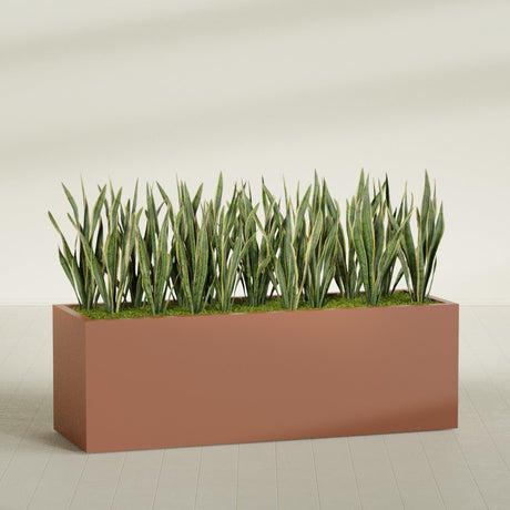 Granada rectangular fiberglass planter in Matte Terra Cotta, 72 × 24 × 24 in, shown planted in a room