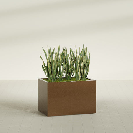 Granada rectangular fiberglass planter in Metallic Bronze, 36 × 24 × 24 in, shown planted in a room