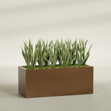 Granada rectangular fiberglass planter in Metallic Bronze, 60 × 24 × 24 in, shown planted in a room