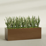 Granada rectangular fiberglass planter in Metallic Bronze, 72 × 24 × 24 in, shown planted in a room