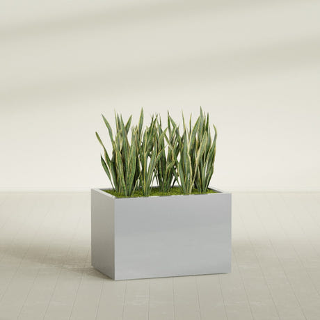 Granada rectangular fiberglass planter in Metallic Silver, 36 × 24 × 24 in, shown planted in a room