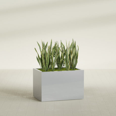 Granada rectangular fiberglass planter in Metallic Silver, 36 × 24 × 24 in, shown planted in a room