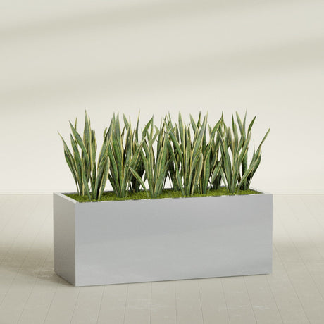Granada rectangular fiberglass planter in Metallic Silver, 60 × 24 × 24 in, shown planted in a room