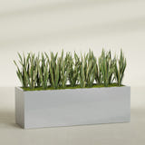 Granada rectangular fiberglass planter in Metallic Silver, 72 × 24 × 24 in, shown planted in a room