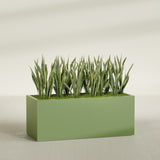 Granada rectangular fiberglass planter in Satin Green, 60 × 24 × 24 in, shown planted in a room