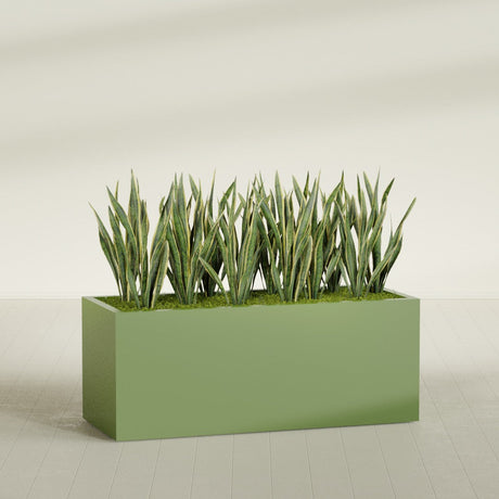 Granada rectangular fiberglass planter in Satin Green, 60 × 24 × 24 in, shown planted in a room