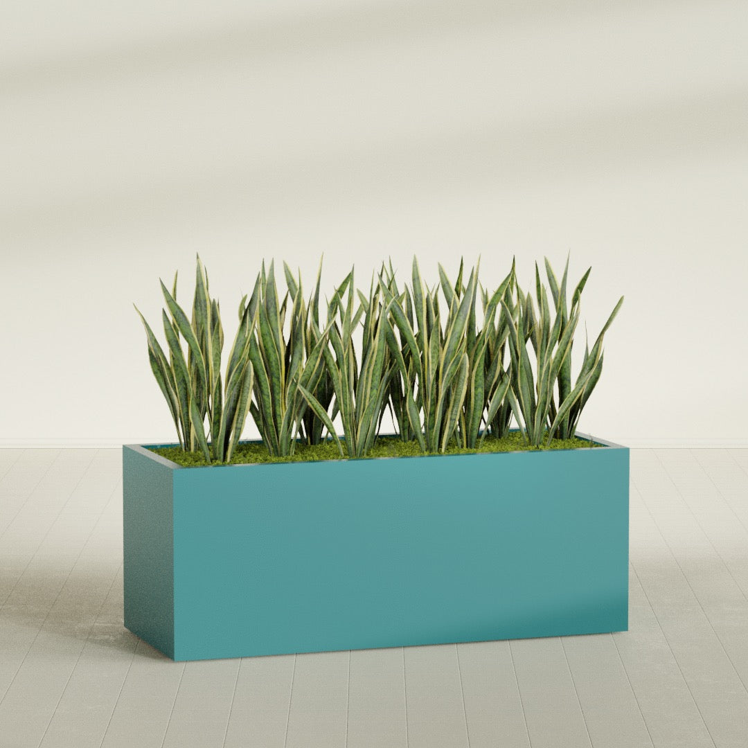 Granada rectangular fiberglass planter in Satin Seafoam Green, 60 × 24 × 24 in, shown planted in a room