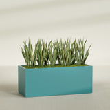 Granada rectangular fiberglass planter in Satin Seafoam Green, 60 × 24 × 24 in, shown planted in a room