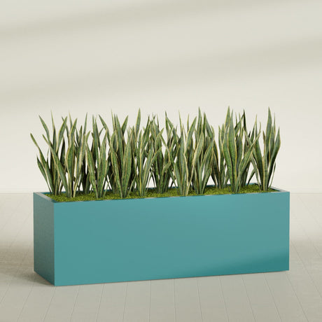 Granada rectangular fiberglass planter in Satin Seafoam Green, 72 × 24 × 24 in, shown planted in a room