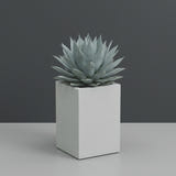 Miami Corner fiberglass planter in Matte Bright White, planted with blue-grey agave, studio