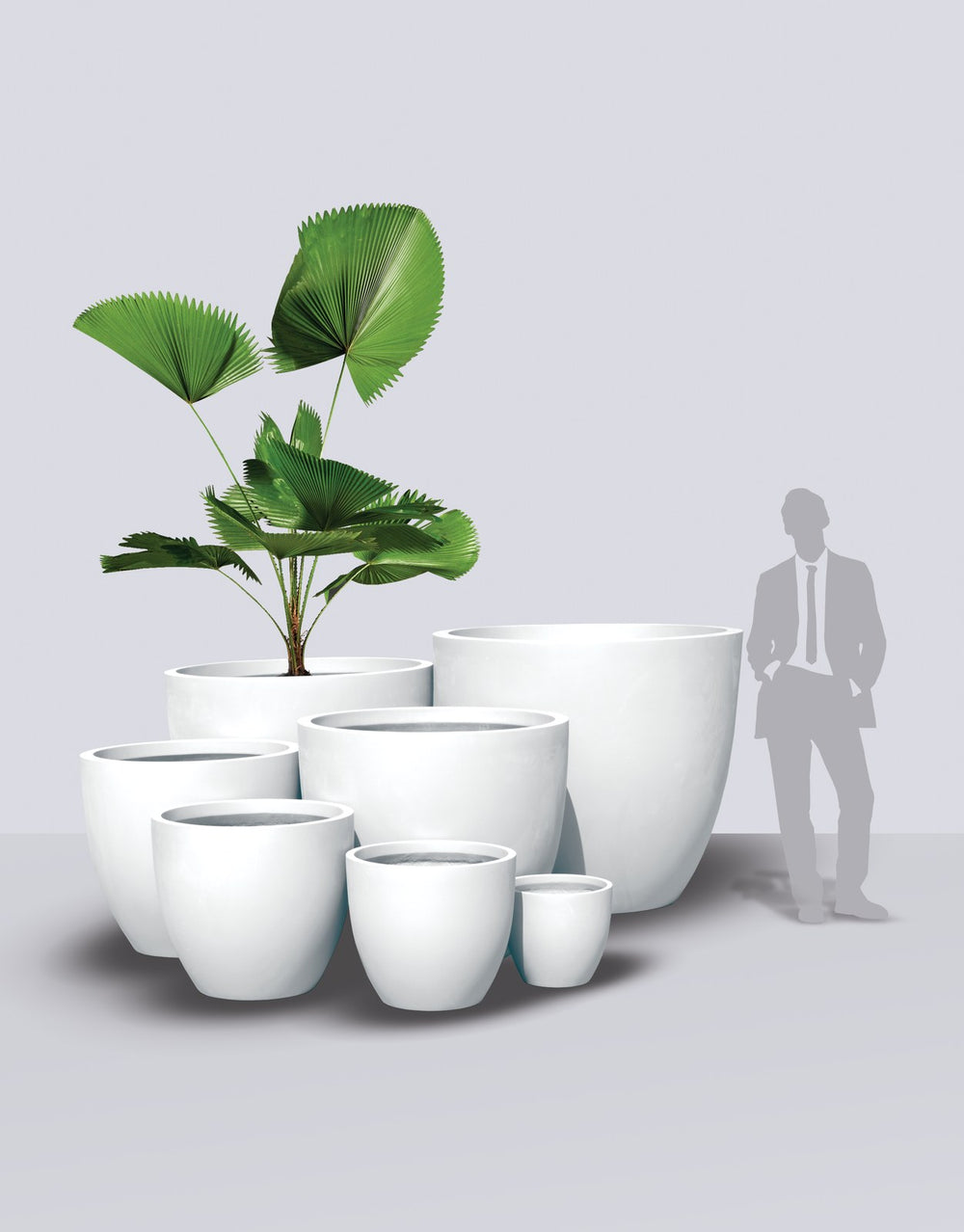 Wannsee Round fiberglass planter size range shown to scale beside a standing figure